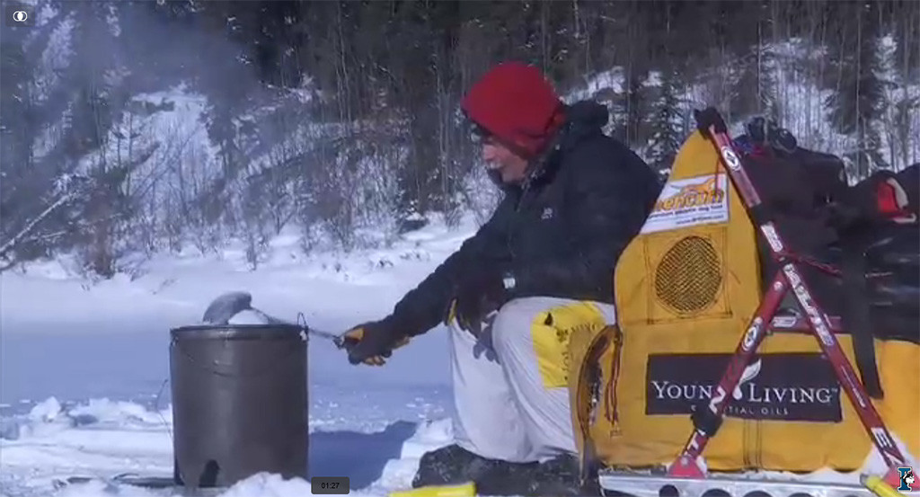 Mitch Seavey melting water on the trail for his dogs. (courtesy Iditarod.com/Iditarod Trail Committee)